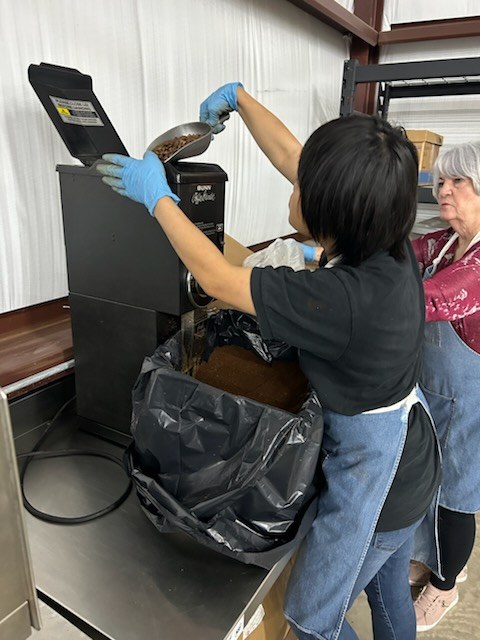 Adulting Well student packing Coffee with a Cause bags